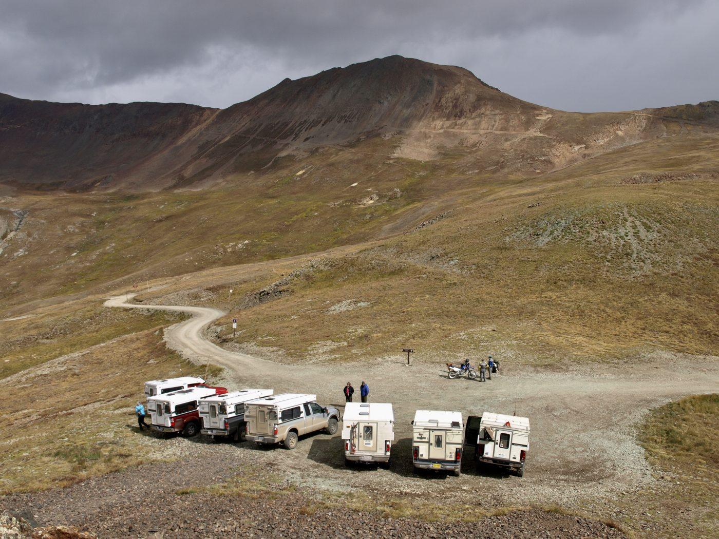 7 four wheel campers in lined up in the mountains