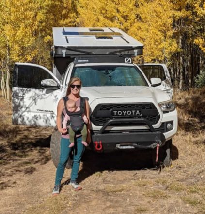 Mother w baby front Toyota Popup Fourwheel Camper